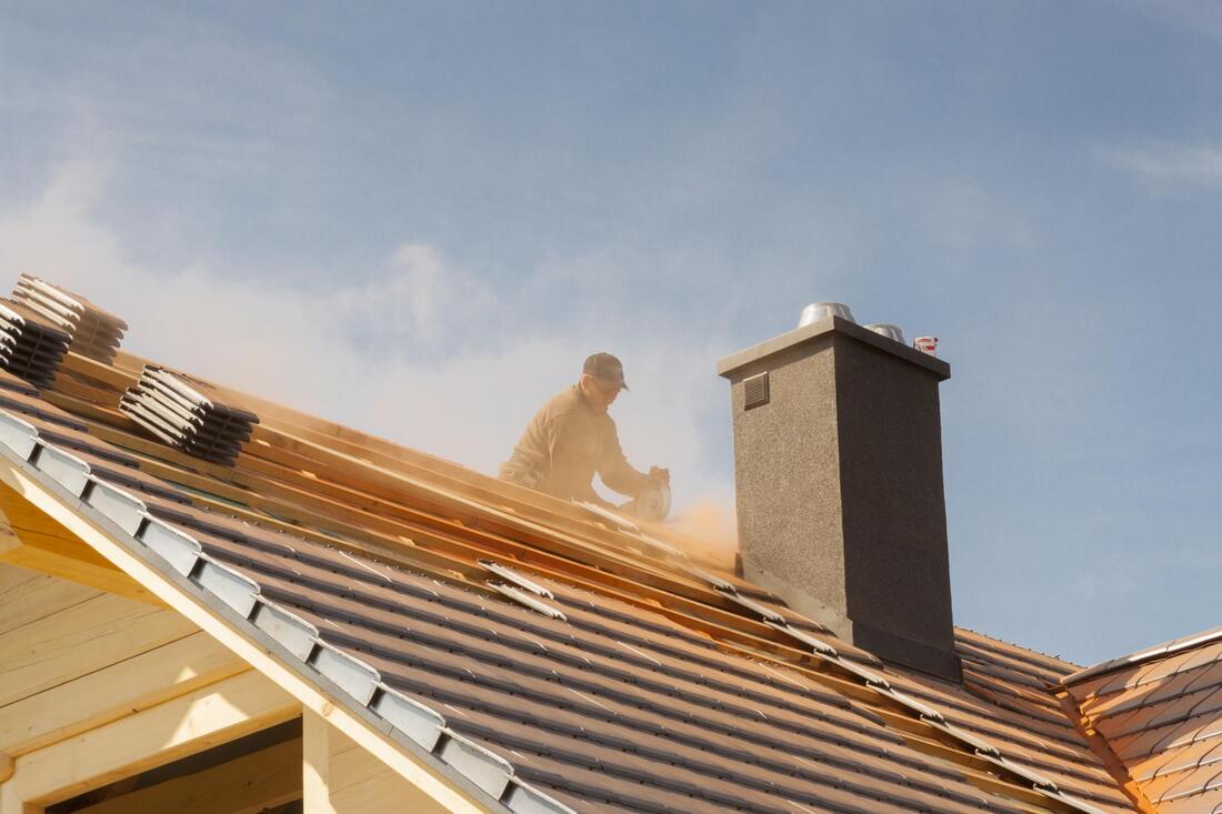 man fixing top of the roof