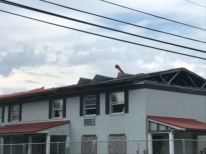 Apartment building roof damage from Hurricane Michael